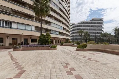 a courtyard in front of a building with two tall buildings at Florazar 2, Vi-1-B in Cullera
