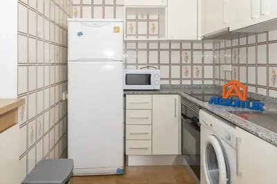 a kitchen with a refrigerator and a microwave at Florazar 2, Vi-1-B in Cullera