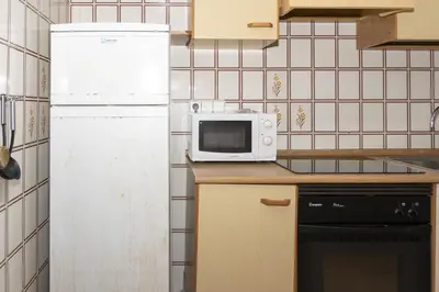 a kitchen with a white refrigerator and a microwave at Florazar 2, Vi-3-B in Faro de Cullera