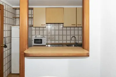 a kitchen with a sink and a microwave at Florazar 2, Vi-3-B in Faro de Cullera