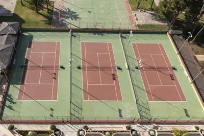 an overhead view of a tennis court with red lanes at Florazar 2, Vi-3-B in Faro de Cullera