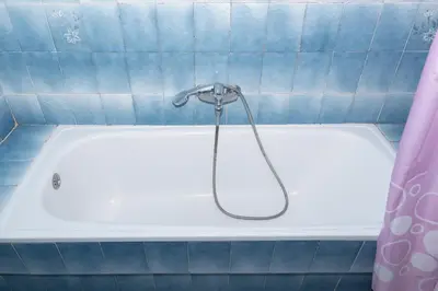 a bath tub with a shower in a bathroom at Florazar 2, Vi-3-B in Faro de Cullera