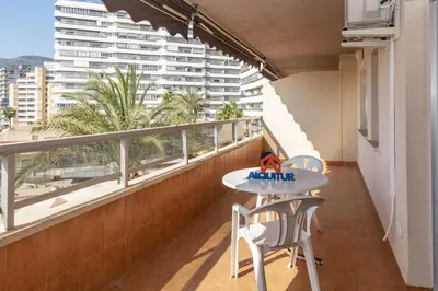 a balcony with a table and chairs and a view of a building at Florazar 2, Vi-3-B in Faro de Cullera