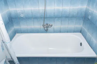 a white bath tub in a blue tiled bathroom at Florazar 2, Vi-5-B in Cullera