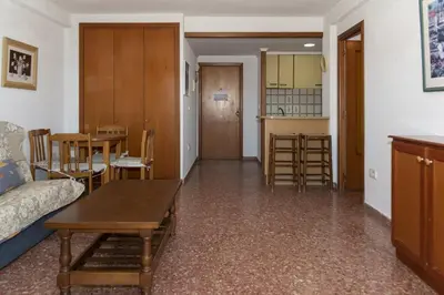 a living room with a couch and a table and a kitchen at Florazar 2, Vi-7-C in Cullera