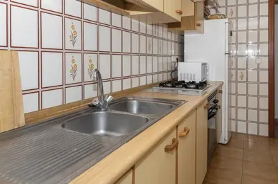 a kitchen with a stainless steel sink and a stove at Florazar 2, Vii-2-A in Faro de Cullera