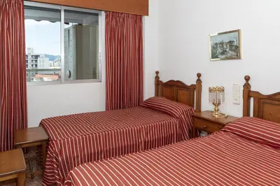 a hotel room with two beds and a window at Florazar 2, Viii-8-B in Cullera