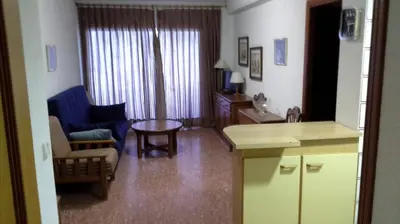 a living room with a couch and a chair and a table at Florazar 2, Viii-8-B in Cullera