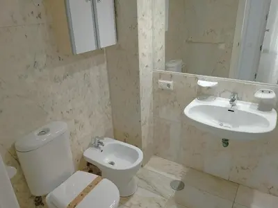 a bathroom with a toilet and a sink at Florazar 3, 3-C in Cullera