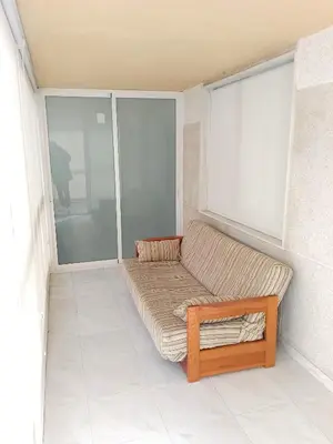 a couch sitting in the corner of a room at Florazar 3, 3-C in Cullera
