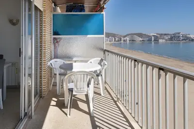 a balcony with a table and chairs and a view of the ocean at Frontalmar, Esc-A, 8º-29 in Cullera