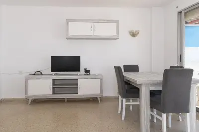 a dining room with a table with a television on it at Frontalmar, Esc-A, 8º-29 in Cullera