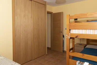 a bedroom with two bunk beds and a closet at Frontalmar, Esc-B, 8º-32 in Cullera