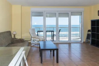 a living room with a couch and a table at Frontalmar, Esc-B, 8º-32 in Cullera