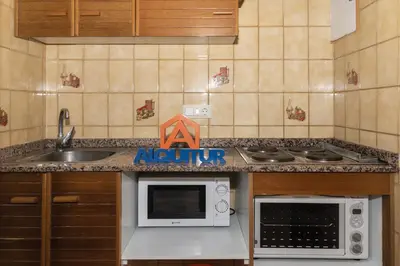 a kitchen with a sink and a microwave at Las Vegas, Esc-3, 7º-19 in Cullera