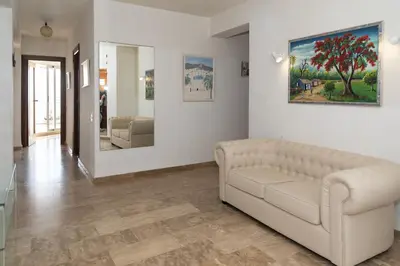 a living room with a couch and a painting on the wall at LIDER, 12º-A Atico in Cullera