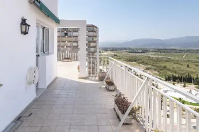 a balcony with a view of a building at LIDER, 12º-A Atico in Cullera