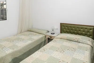 two twin beds in a room with a table at Lider, 2-G in Cullera