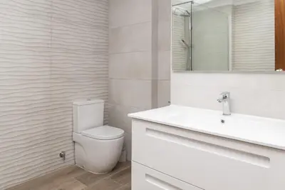 a bathroom with a toilet and a sink and a mirror at Lider, 2-G in Cullera