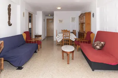 a living room with red and blue couches and a table at Lider, 2-I in Cullera
