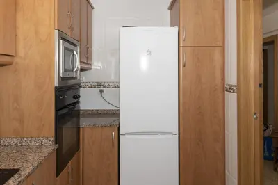 a white refrigerator in a kitchen with a microwave at Lider, 2-I in Cullera