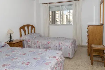 a bedroom with two beds and a window at Lider, 2-I in Cullera