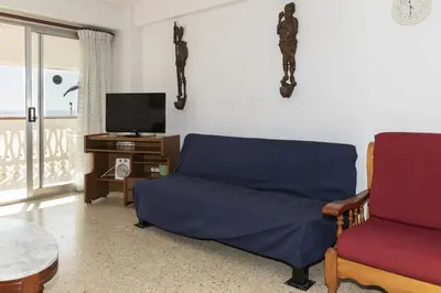 a living room with a couch and a tv at Lider, 2-I in Cullera