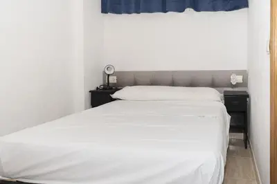 a bedroom with a white bed and a window at Lider, 44-E (Planta Baja) in Cullera