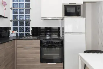 a kitchen with a refrigerator and a stove and a microwave at Lider, 44-E (Planta Baja) in Cullera