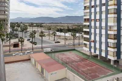 a view of a building with a tennis court on the roof at Lider, 4-D in Cullera
