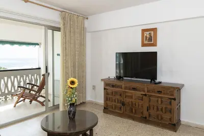 a living room with a television and a table at Lider, 5-B in Cullera