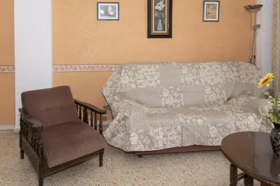 a living room with a couch and a chair at Lider, 5-B in Cullera