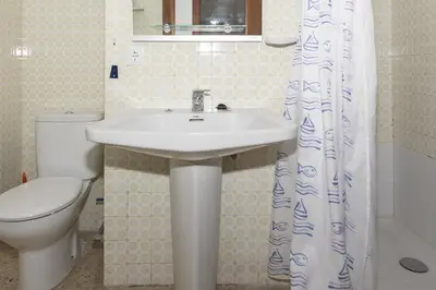 a bathroom with a sink and a toilet at Lider, 5-B in Cullera