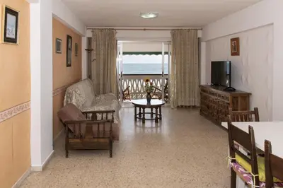 a living room with a couch and a television at Lider, 5-B in Cullera