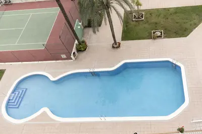 an overhead view of a swimming pool with a tennis court at Lider, 5-B in Cullera