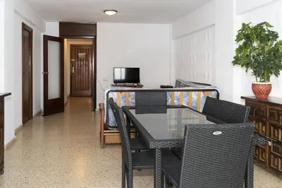 a dining room with a table and chairs at Lider, 5-C in Cullera