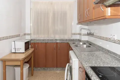 a small kitchen with a sink and a microwave at Lider, 5-C in Cullera