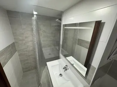 a bathroom with a shower and a sink and a mirror at Lider, 5-C in Cullera