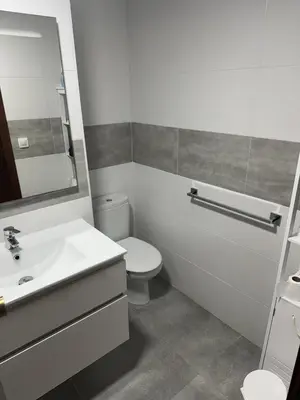 a bathroom with a toilet and a sink and a mirror at Lider, 5-C in Cullera