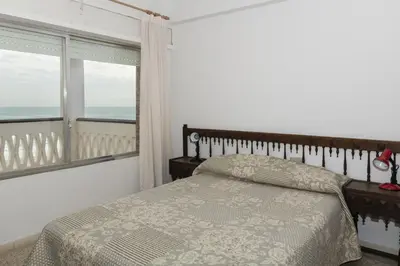 a bedroom with a bed and a large window at Lider, 8-A in Cullera
