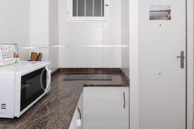 a kitchen with a microwave and a counter top at Mar Y Montaña 7º-119 in Cullera
