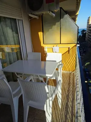 a white table and chairs on a balcony at Mar Y Montaña 7º-119 in Cullera