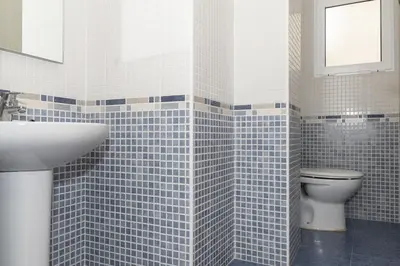 a bathroom with a toilet and a sink at Miralmar, 10º-69 in Cullera