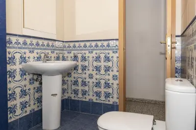 a bathroom with a sink and a toilet at Miralmar, 10º-69 in Cullera