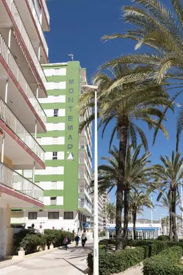 a hotel on the beach with palm trees and a street light at Montemar, B-9º-26 in Cullera