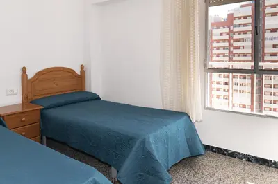 a bedroom with a bed and a window at Montemar, C-12º-33 in Cullera