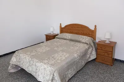 a bedroom with a bed and two night stands at Montemar, C-12º-33 in Cullera