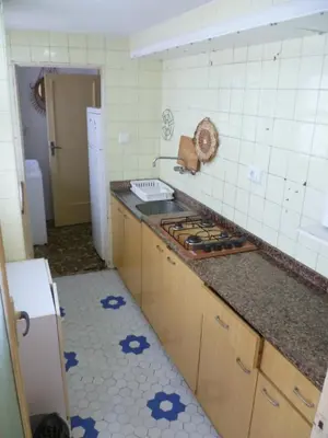 a kitchen with a sink and a stove top at Nautic, 7º-O in Cullera