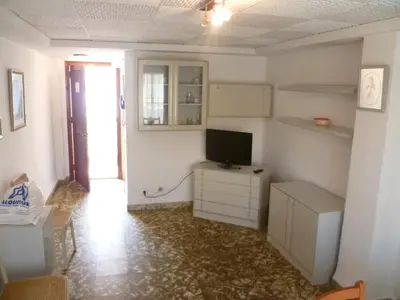 a room with a television on a dresser at Nautic, 7º-O in Cullera