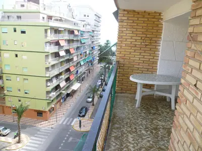 a balcony with a table and a building at Nautic, 7º-O in Cullera